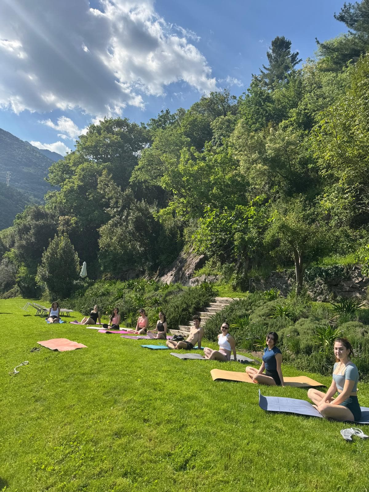 Youva retreat practice on a lakeside meadow in the Alps