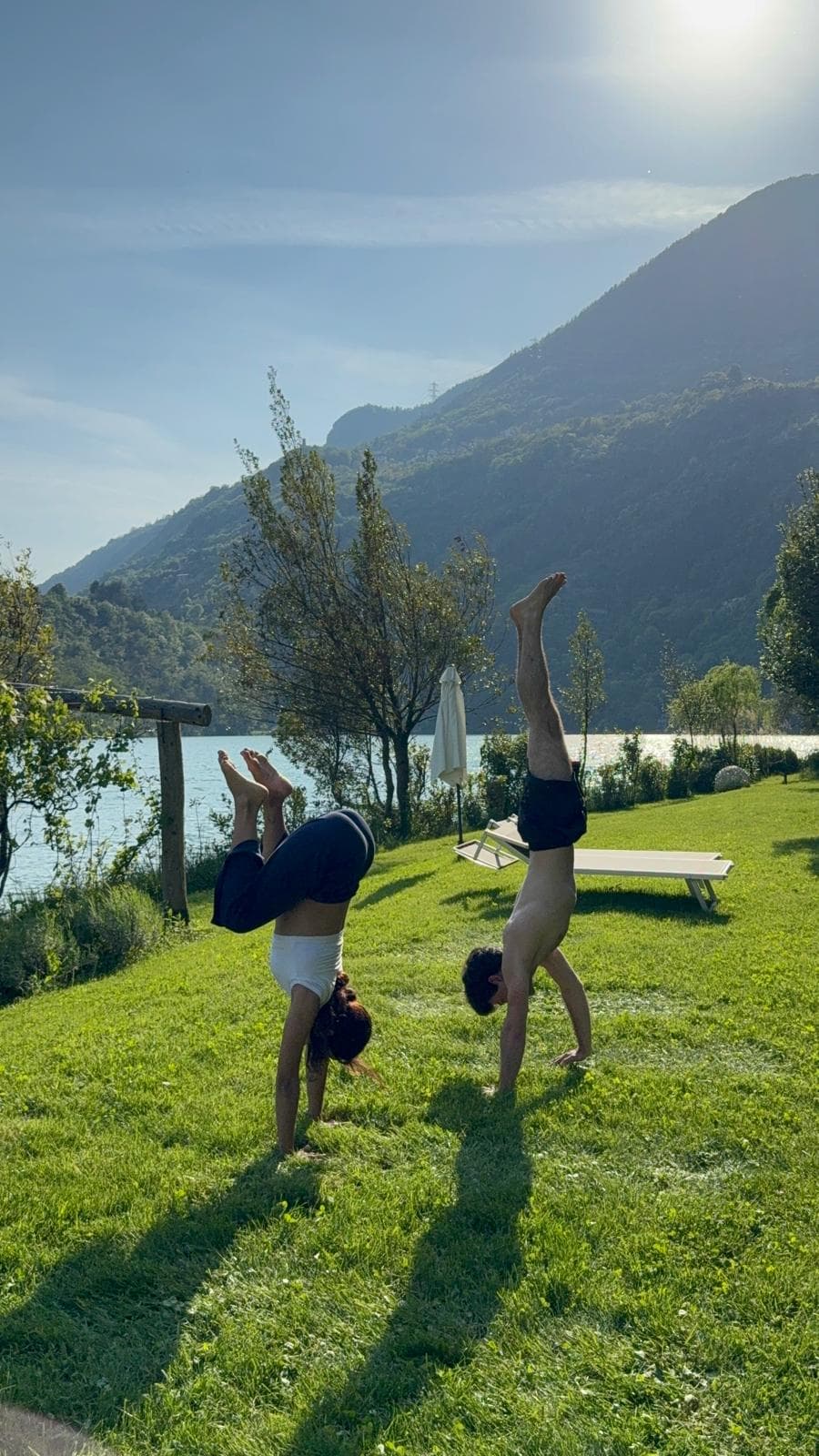 Playful handstands at the lake during a Youva retreat